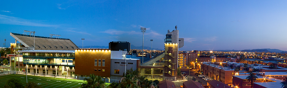 The Lowell-Stevens Football Facility, Arizona Stadium, and the Highland District dorms at dusk
