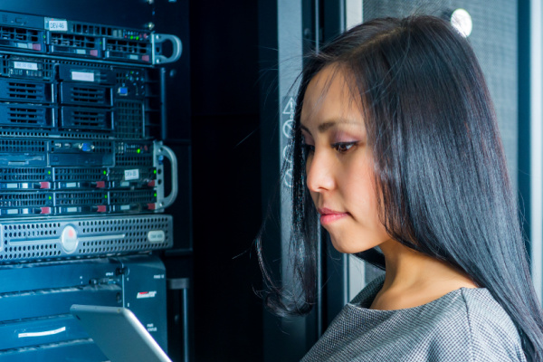 Network technician working in a server room