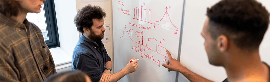 Group of engineers working at a whiteboard