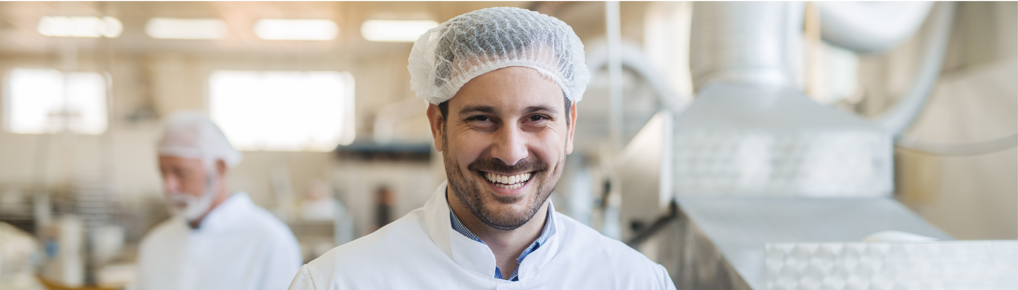 Smiling man in a food factory