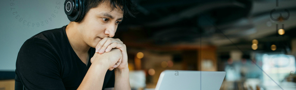 Adult student wearing headphones and taking an online math refresher class