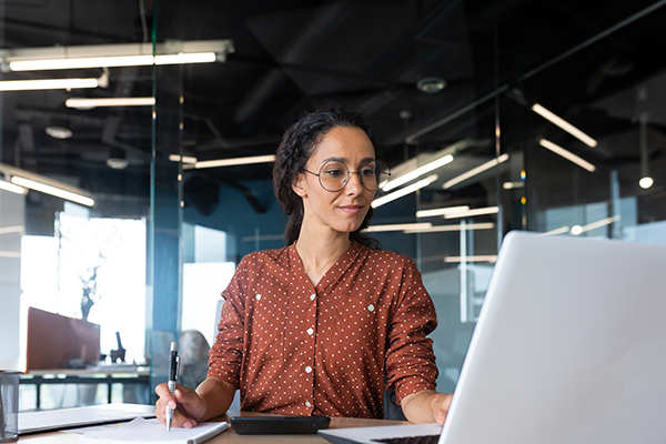 SHRM-certified professional working at her desk in an office