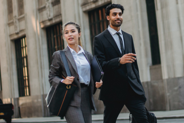 Paralegal and attorney walking down the street