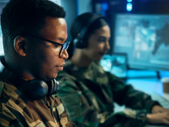 military male and female working in an operations room