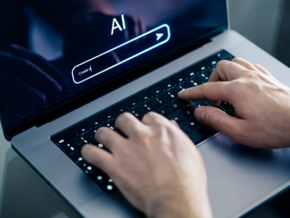 Person using ChatGPT on a laptop to create content