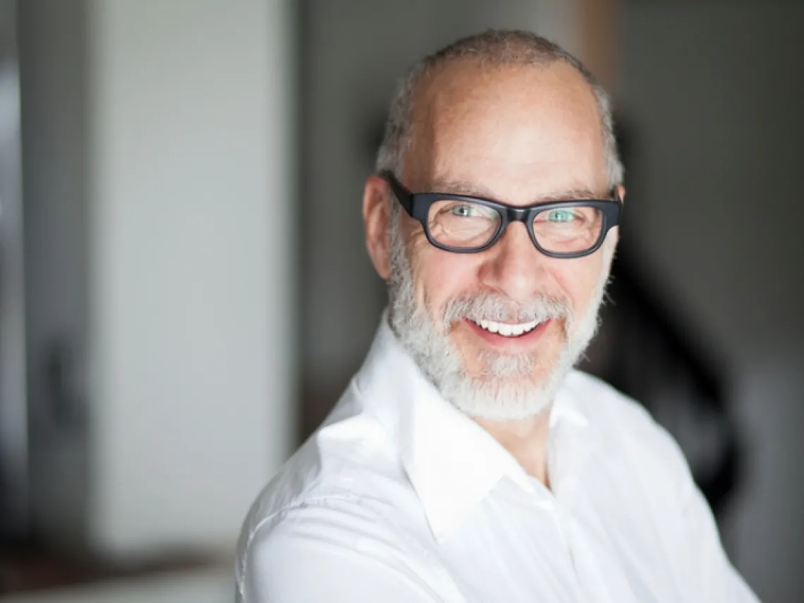 image of an older man wearing glasses and smiling