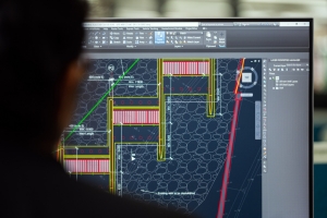 Female engineer using AutoCAD to plan a dam