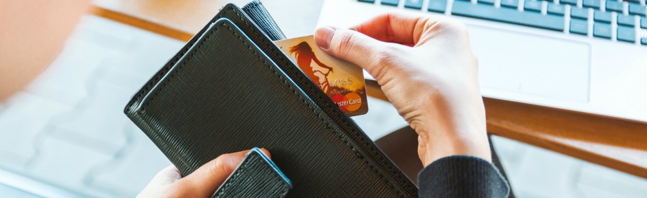 Person pulling credit card out of their wallet