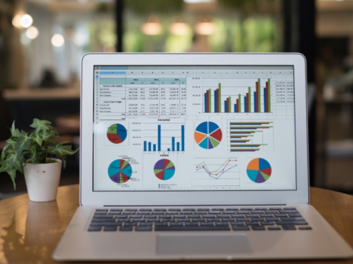 Laptop showing spreadsheet with charts and graphs