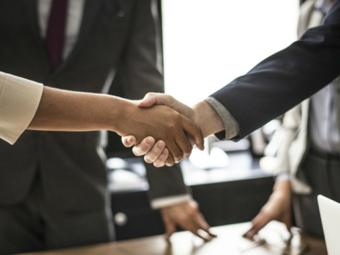 Alternative Dispute Resolution training Man and woman shaking hands after successful dispute resolution