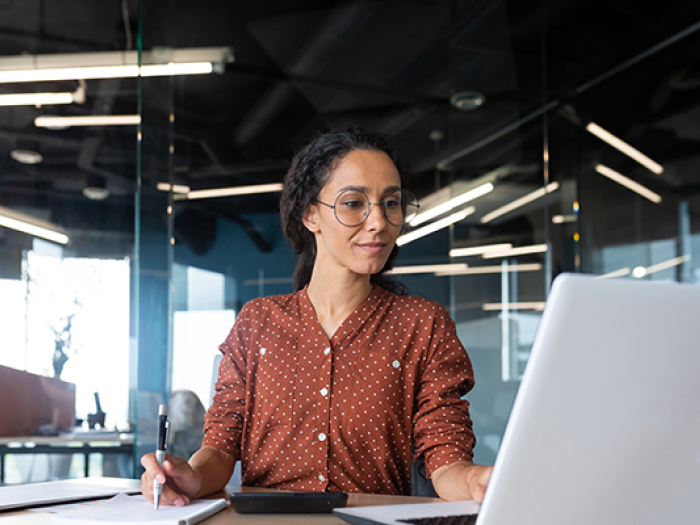 SHRM-certified professional working at her desk in an office