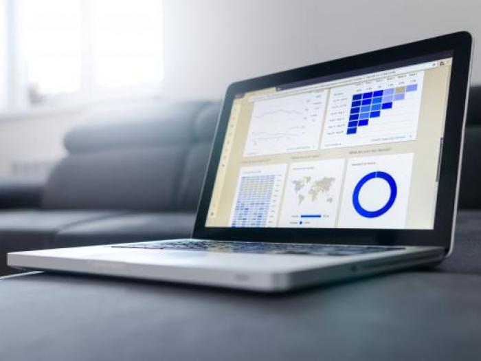 Laptop showing charts and graphs on-screen