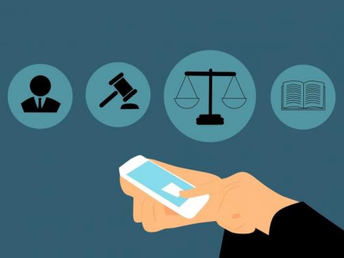Paralegal Certificate Course Paralegal checking for messages with legal icons in the background
