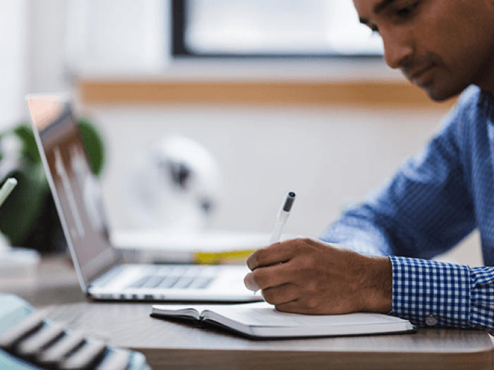 Man working on a grant proposal at his desk