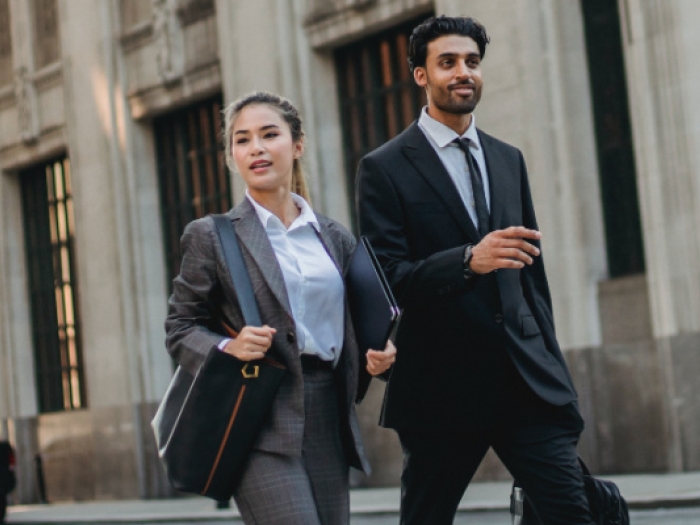 Paralegal and attorney walking down the street