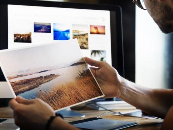 Photoshop Intermediate Designer looking at photographs