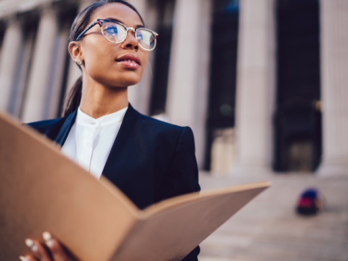 Paralegal standing in front of a courthouse