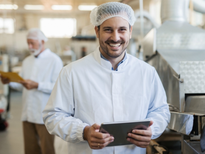 Food Safety Training Program Smiling man in a food factory