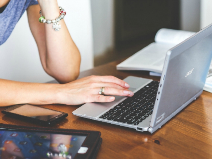 CompTIA A+ Female computer support specialist working on a laptop